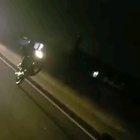 doing a wheelie down the highway at night