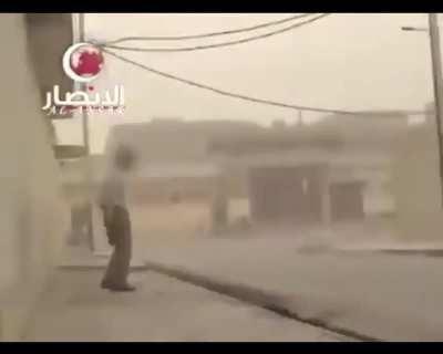 Iraqi insurgent throws a russian parachuted antitank grenade at a passing Stryker IFV.