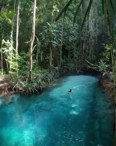 The blue waters of Kali Biru. West Papua, Indonesia