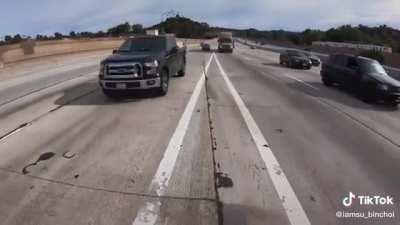 Motorcycle rider helps guy with broken down car to median lane