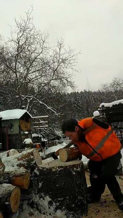 Czech man with no arms chops firewood.