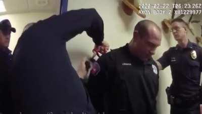 Corrupt police officer has uniform cut off with scissors, when arrested.