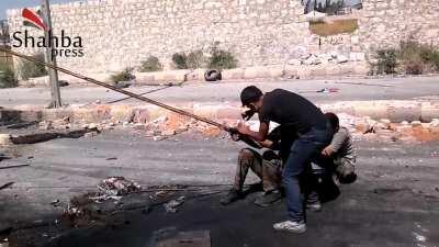 Opposition weapons team uses a sling shot to launch improvised explosives at suspected Gov. positions - Aleppo - September 2013