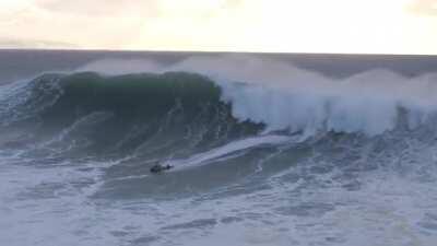 Jet skiier saving surfer from monster wave