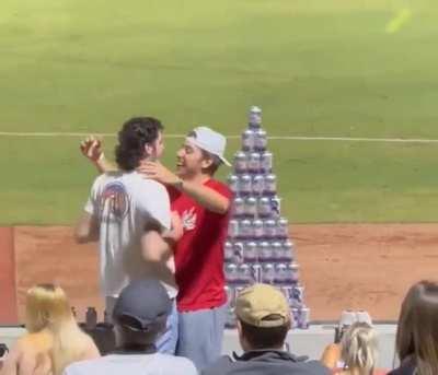 Brotherly Tender Moment Rudely Interrupted By Jerk From the Stands