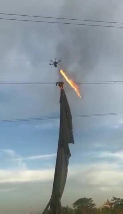 Flamethrower drone clearing litter on power lines