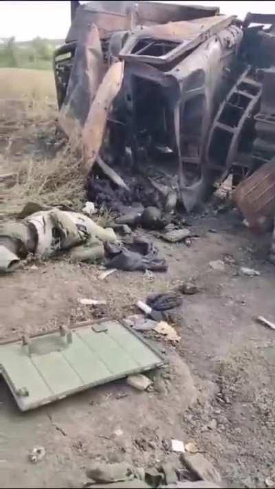 Dead Russians beside a destroyed MLRS