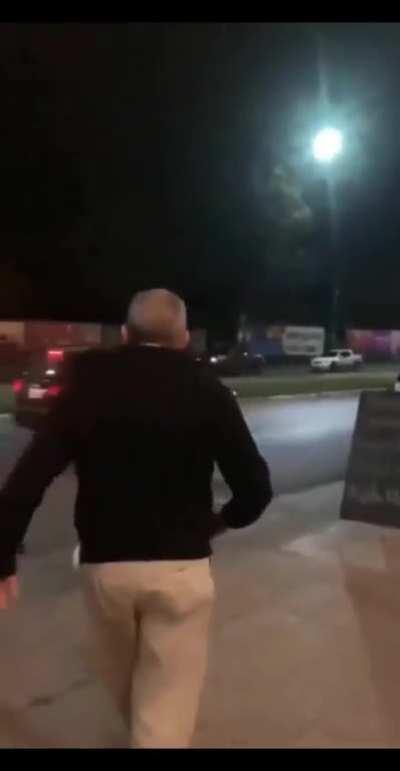 Man snatches someone's skateboard and throws it onto the road.