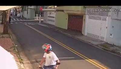 Woman in Rio de Janeiro reacting to seeing a man in a motorcycle next to her (motorcycle robberies are quite common in Rio)