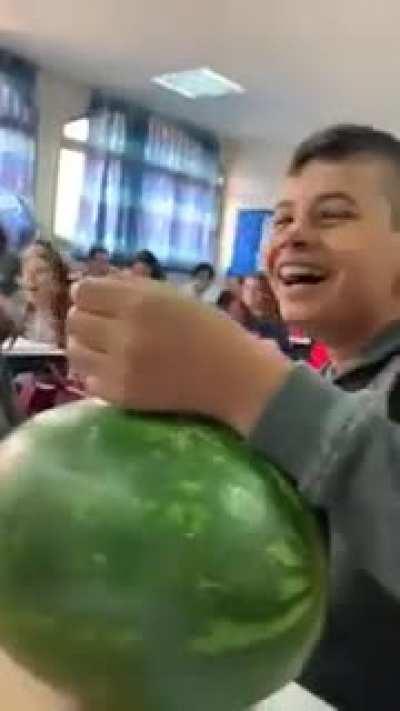 Kid received permission from the teacher to eat a fruit during class.