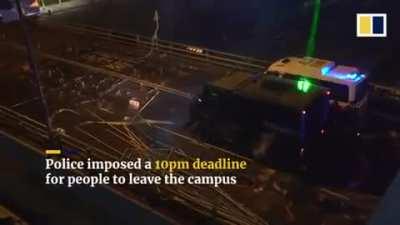 Hong Kong students defend a bridge preventing police from coming in