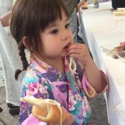 My daughter Discovering Korean Cheese Dogs in Japan.