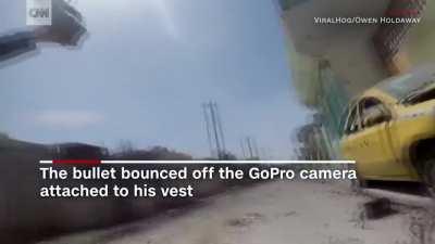 Iraqi cameraman has a bullet miss him by mere centimetres