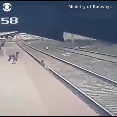 Heart-stopping moment railway employee saves a child that fell onto the tracks.