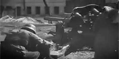 Waffen SS soldiers fire a 10.5 leFH 18 howitzer at point blank range during street fighting in Kharkov.