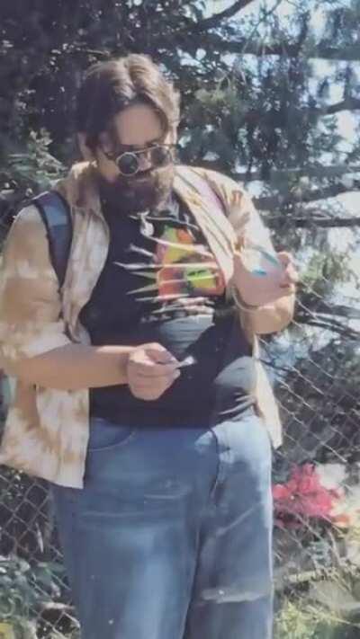 Wizard using a magnifying glass to light up his doobie. This guy deserves the recognition