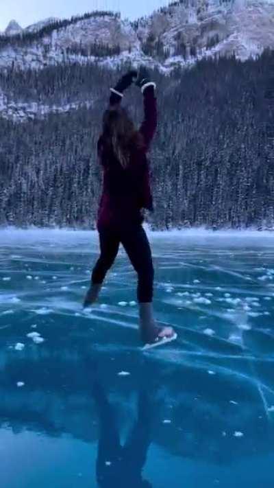 This lady skating on Lake Louise with magnificent mountain backdrop