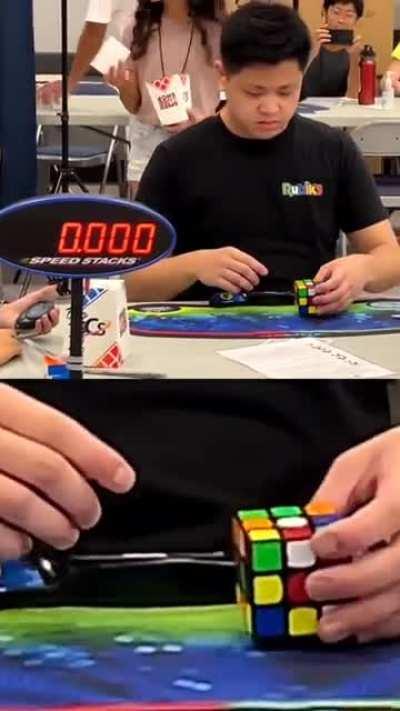 Max Park solving a 3×3 Rubik's cube single-handed in a World Record 6.2s. He's so much in the momentum that he immediately picks up another cube on the table after he's done with the target.