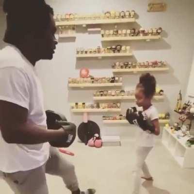 Little girl showing amazing skill sparring with her Dad