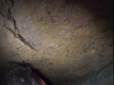 Using your helmet to test the height of a cave crawl