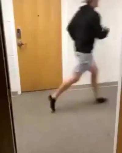 College students fleeing from a ferocious beast that found its way into their dorm