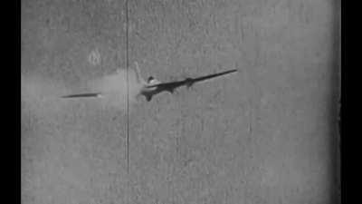 B-17 Flying Fortress crewman bails out as his bomber is under fire from a Luftwaffe fighter