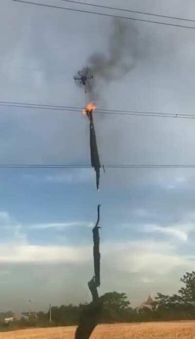 A drone with a flamethrower to remove debris caught on electric wires.