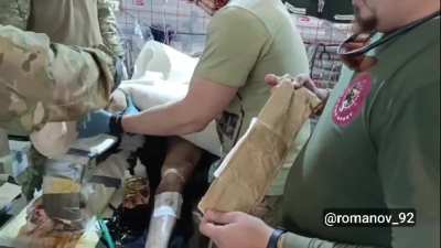 A Russian soldier's mangled foot is treated in a field hospital, they change the wound dressing and get ready to move him, reportedly in the Chasiv Yar area [October 2024]