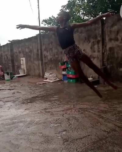 Anthony from Nigeria Dancing ballet barefooted on concrete while raining.