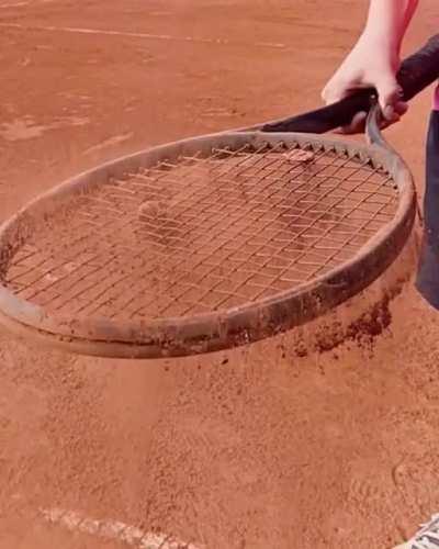 Slow Motion: Dust Inertia on Tennis Racquet