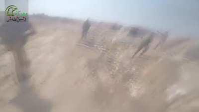 FSA affiliated Army Of Glory utilize a heavy engineering vehicle to cross open ground under enemy fire and assault their positions. Northern Hama, Syria.