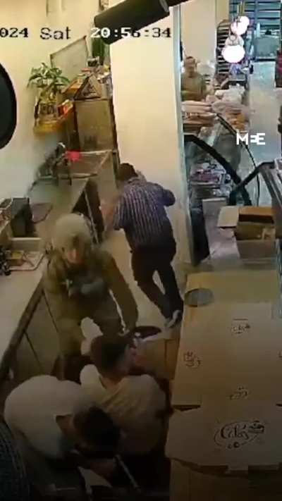 Surveillance footage shows Israeli soldiers entering a bakery in a village northwest of Ramallah, in the West Bank and assaulting the Palestinians