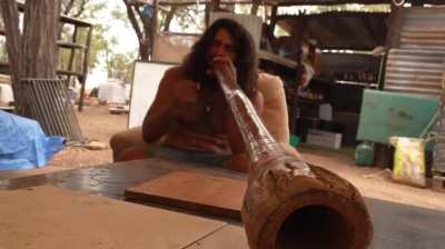 Man Playing the Didgeridoo to DnB