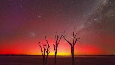 This aurora australis with the Milky Way spinning in the background