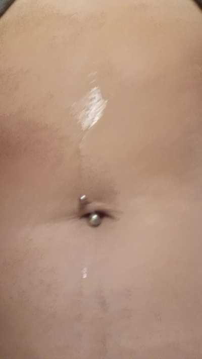 Dropping beads of sweat on my navel 