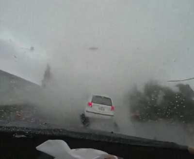 White car cuts off driver and gets swallowed by a tornado