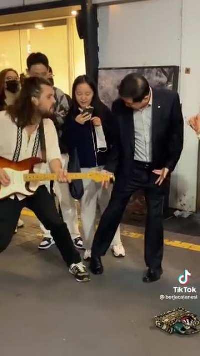 The crowd vibes out with a busker in South Korea