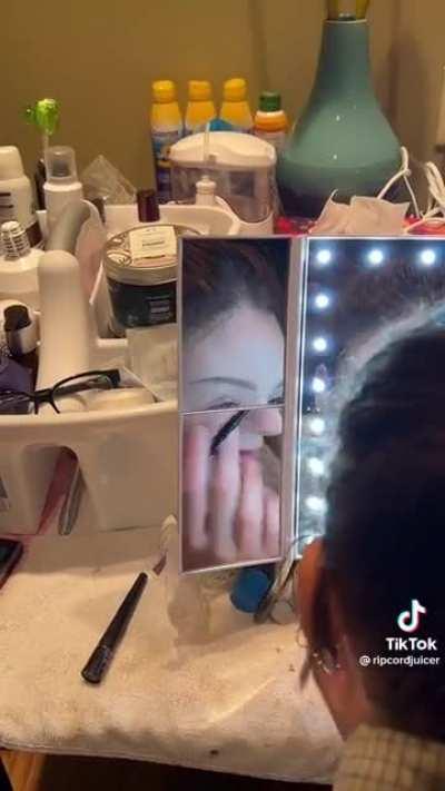 Doing her makeup