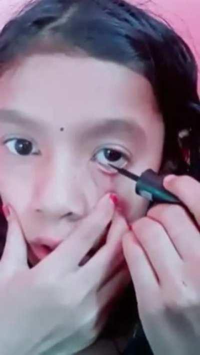 Applying eyeliner