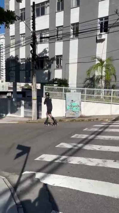 Man is rollerblading down the street