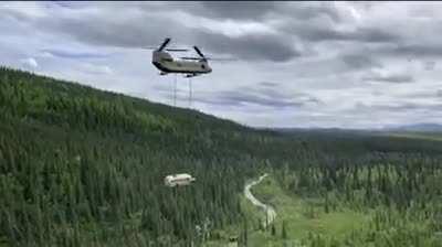 An Alaska Army National Guard CH-47 Chinook helicopter airlifting the &quot;Magic Bus” out of the woods just north of Denali National Park and Preserve in Alaska