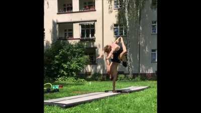 Jumping through the legs of a guy doing a one-handed handstand