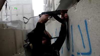 FSA fighters suppress blindly over the wall while others assault up a ladder - Daraya - 12/11/2014