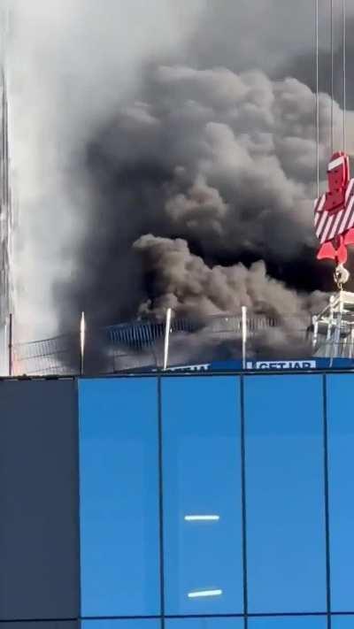 Construction worker is rescued from high-rise fire by crane operator in Reading, UK.