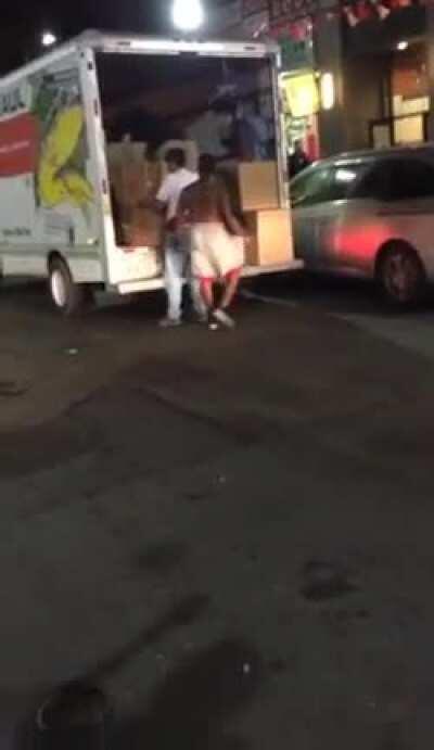 Guy gets knocked out by a truck driver who is trying to unload at a store in China Town (Might be a repost)