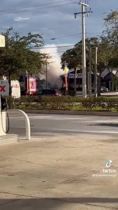 Car drives into fireworks store, sparks fly.