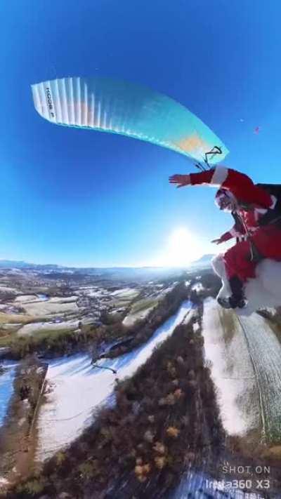 Man takes his dog flying dressed as Santa (Dog is trained for this and they are doing this for a while now and can land safely)