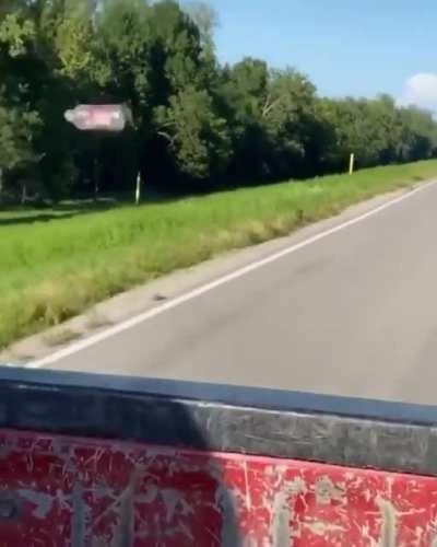 Empty bottle being dragged along a car by aerodynamic drag