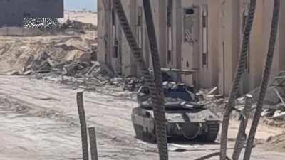 Two Hamas fighters filmed running up to IDF tank on wide open road in Rafah and planting explosives underneath the turret.