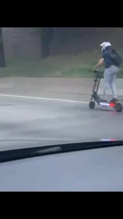 man rides electric scooter on the highway on 50mph joyride